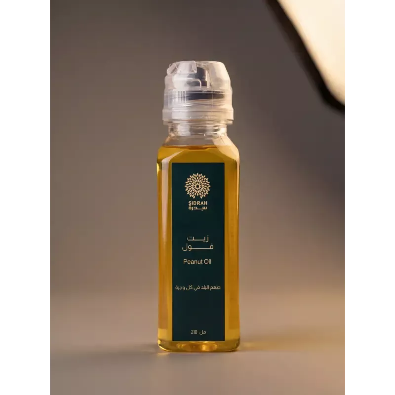 عبوة زيت فول سوداني طبيعي نقي من "سدرة" سعة 210 مل، زيت ذهبي في زجاجة أنيقة بتصميم عصري وشعار ذهبي.